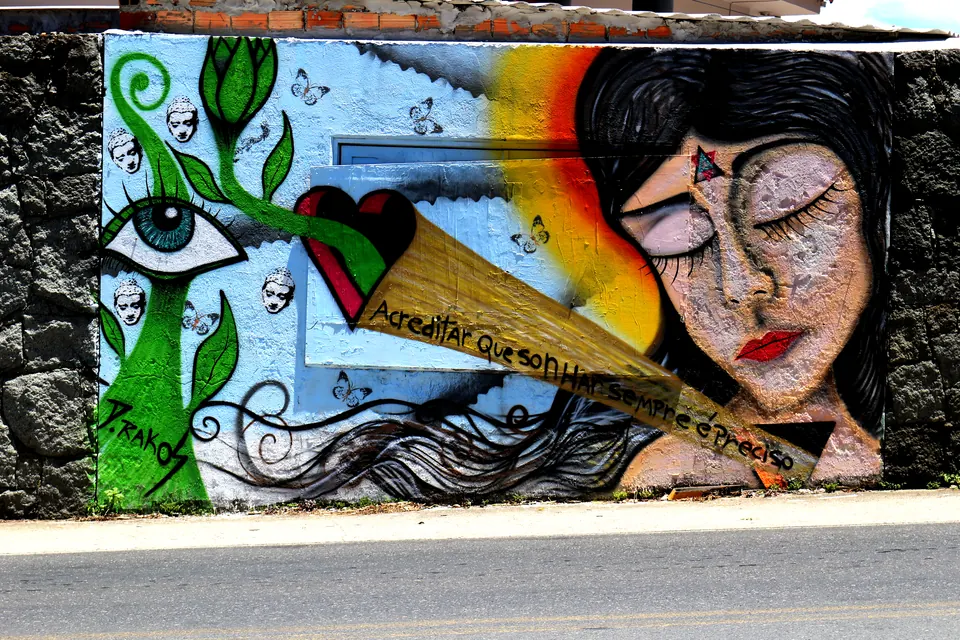 Mural of a sleeping woman beside a rainbow