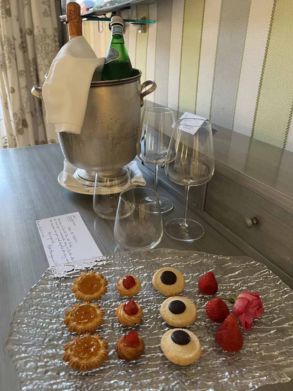 Champagne on ice with glasses and petits fours