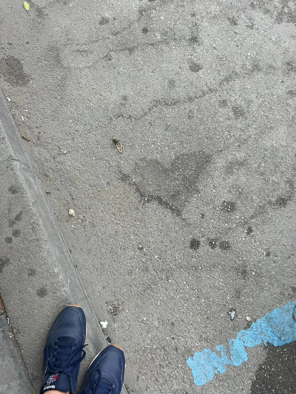 Sneakers on a concrete floor beside a heart shape