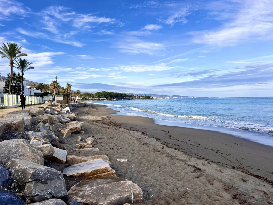 A rocky beach under a blue sky