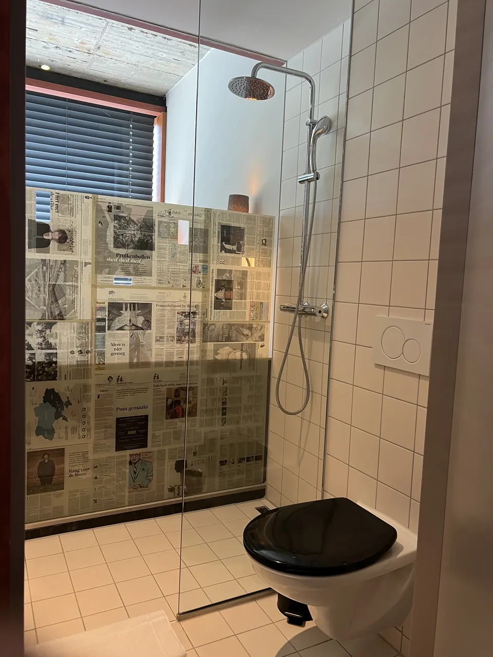 A shower with a newspaper print wall