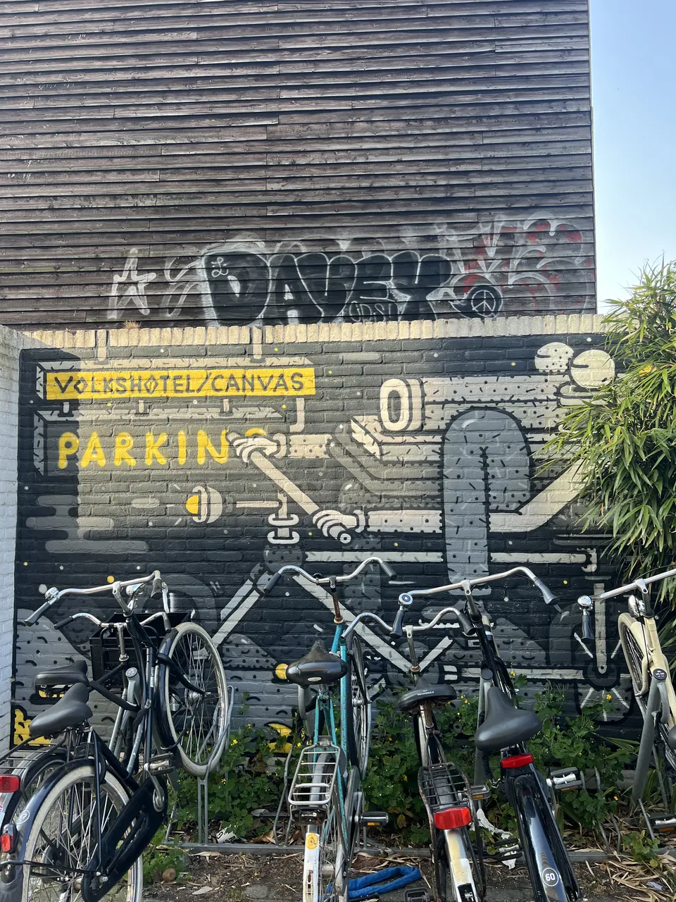 A graffiti wall above parked bicycles
