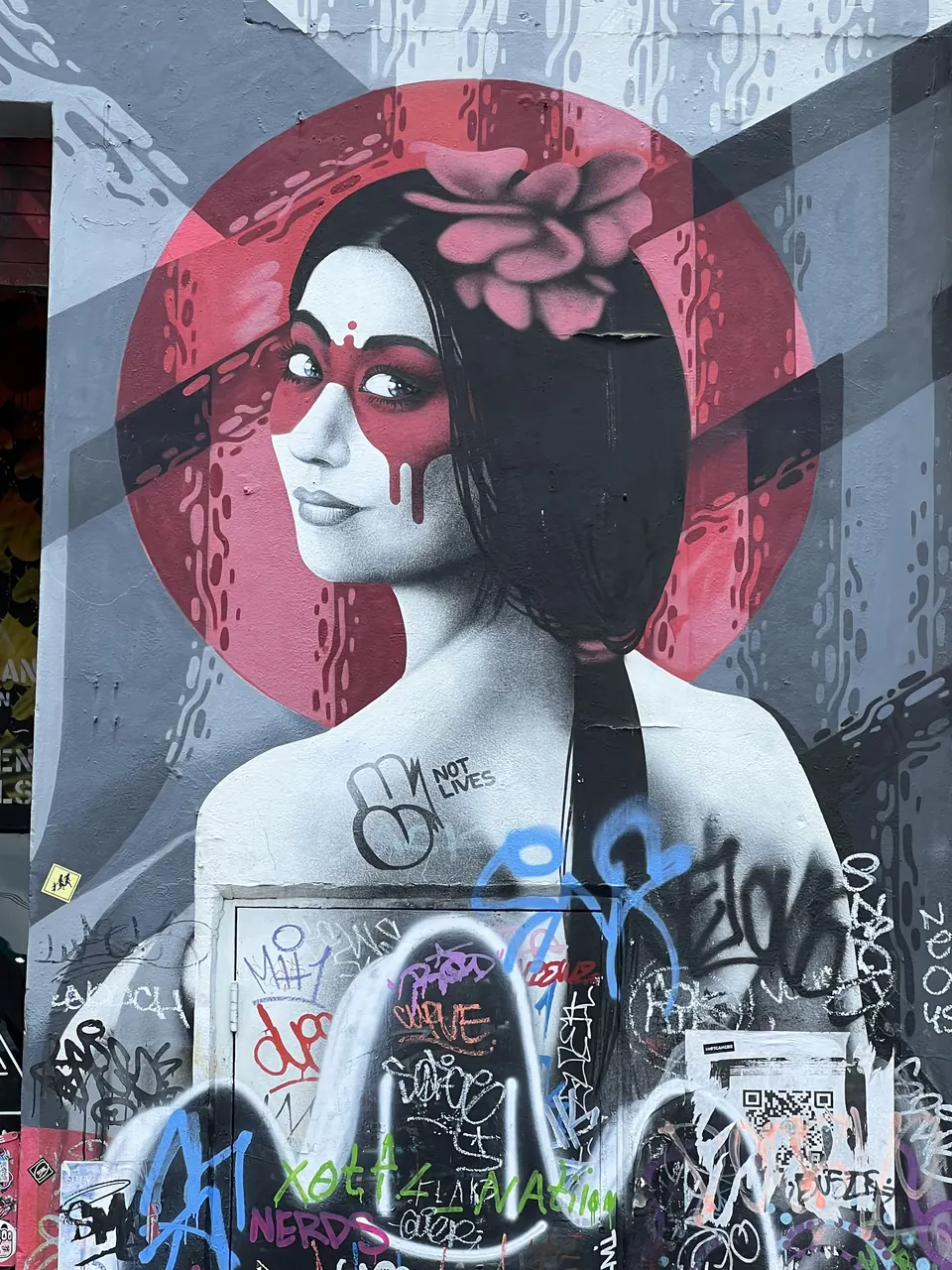 Mural of a woman with a red mask and a flower